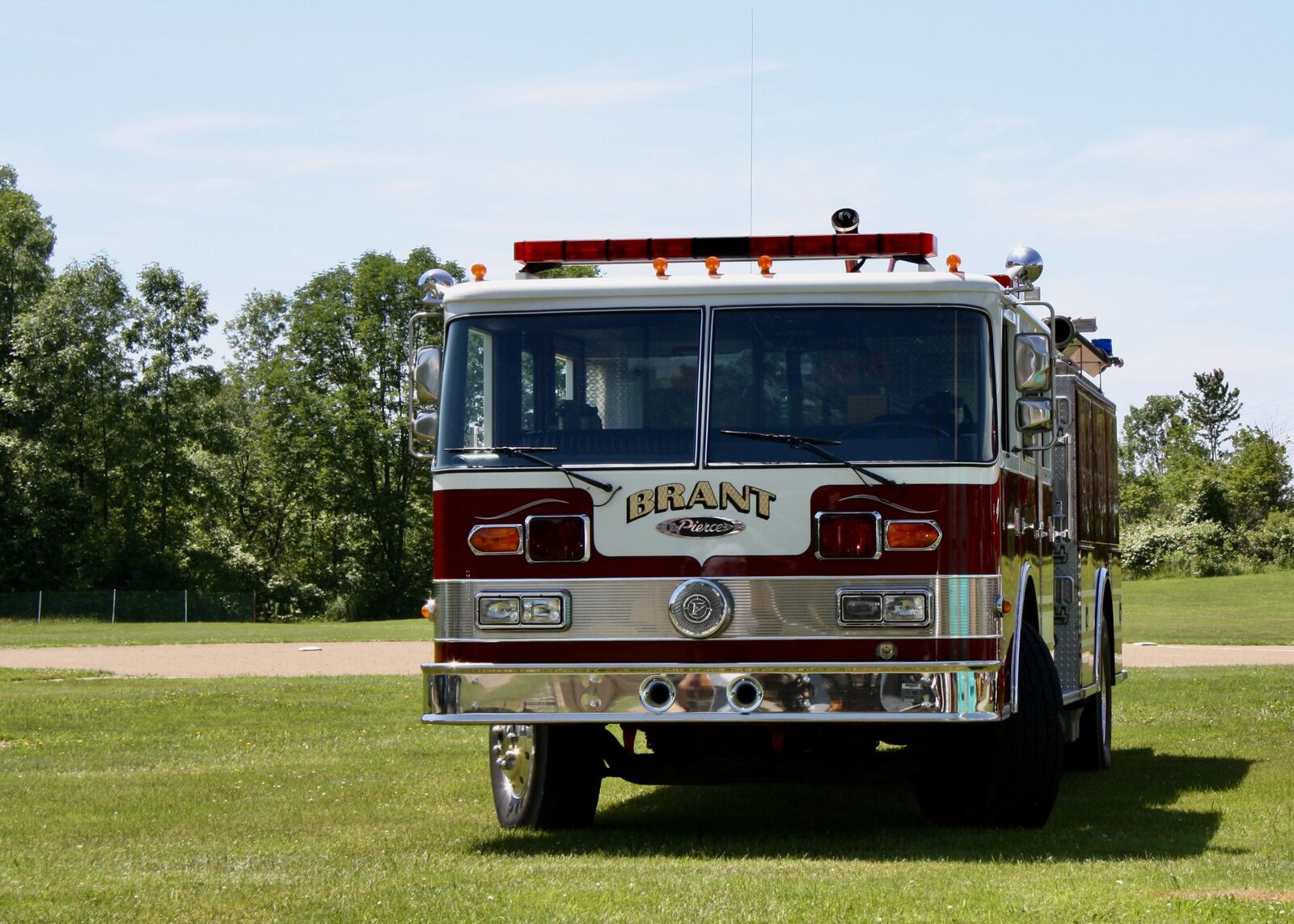 Brant volunteer fire truck parked on a green field on a sunny day
