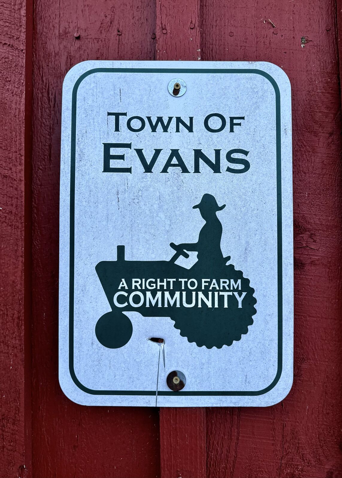 Town of Evans sign — A Right to Farm Community — mounted on a red barn